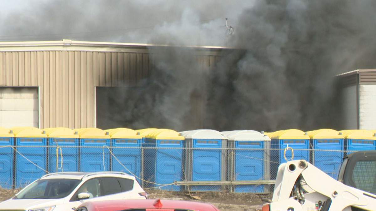 Smoke billows from LORAAS Disposal’s building on the 600 block of McLeod Street on Sunday