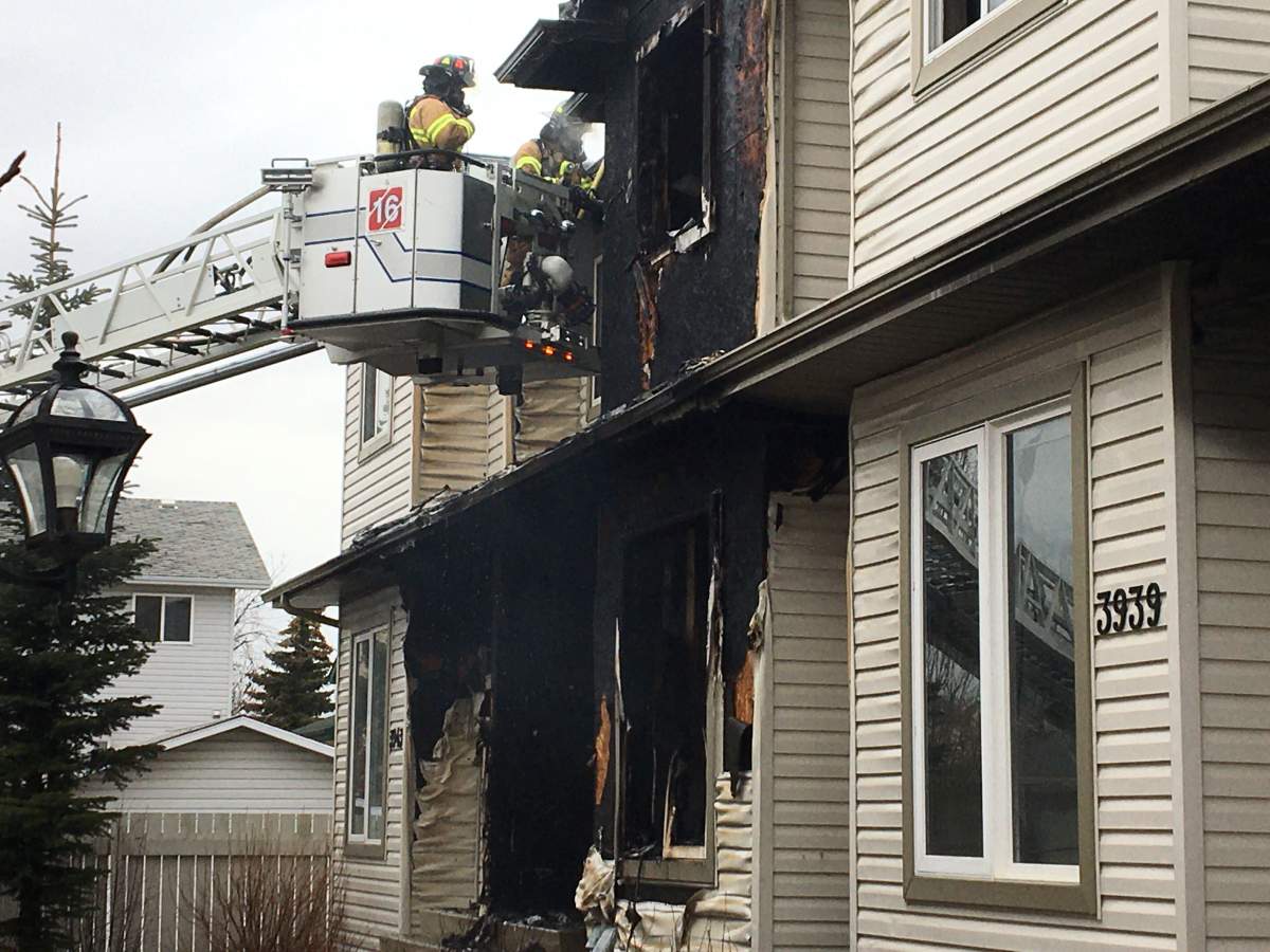 Edmonton firefighters battle a blaze at a fourplex in the area of 39 Avenue and 38 Street Monday, April 20, 2020.