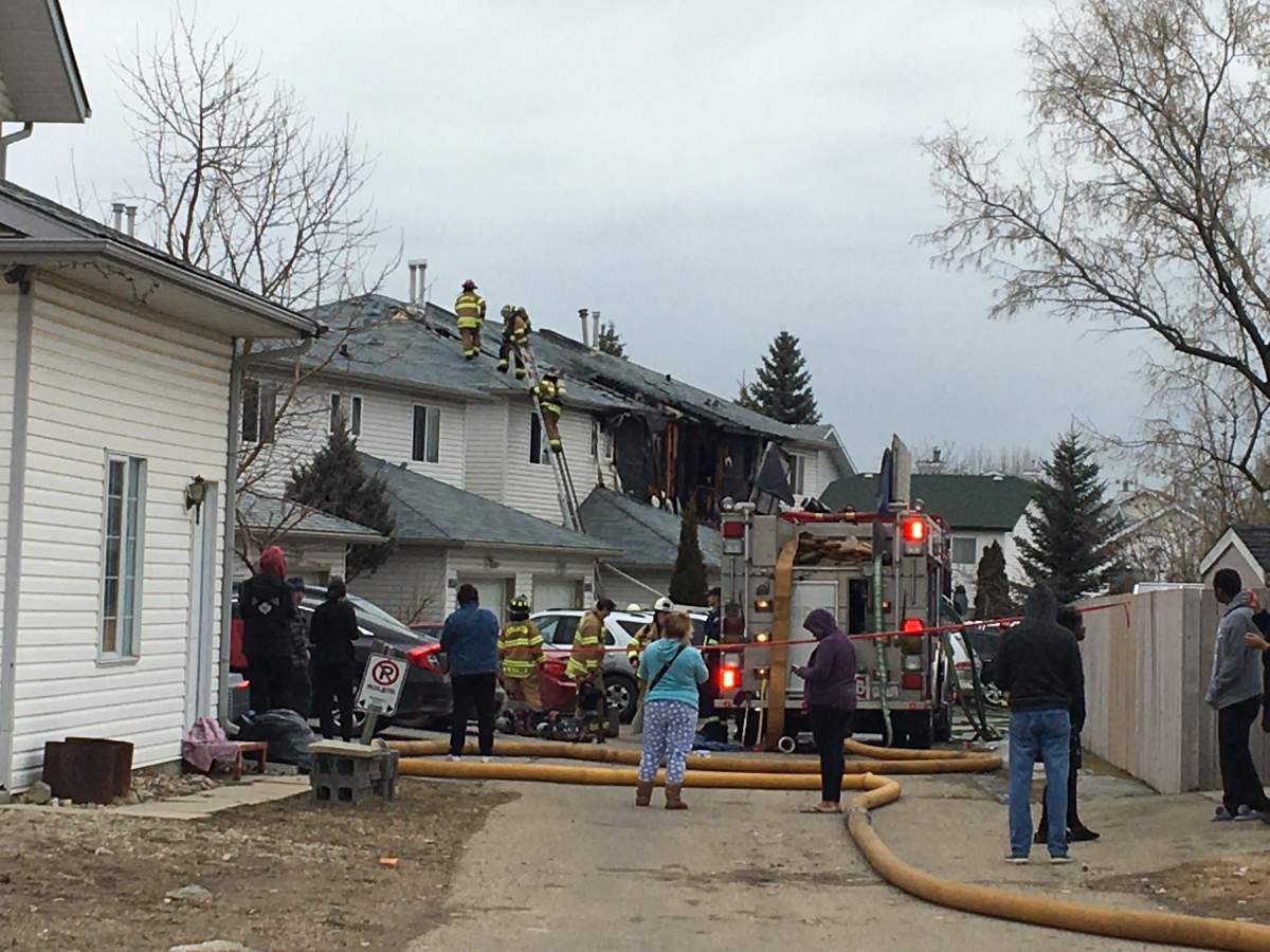 Edmonton firefighters battle a blaze at a fourplex in the area of 39 Avenue and 38 Street Monday, April 20, 2020.