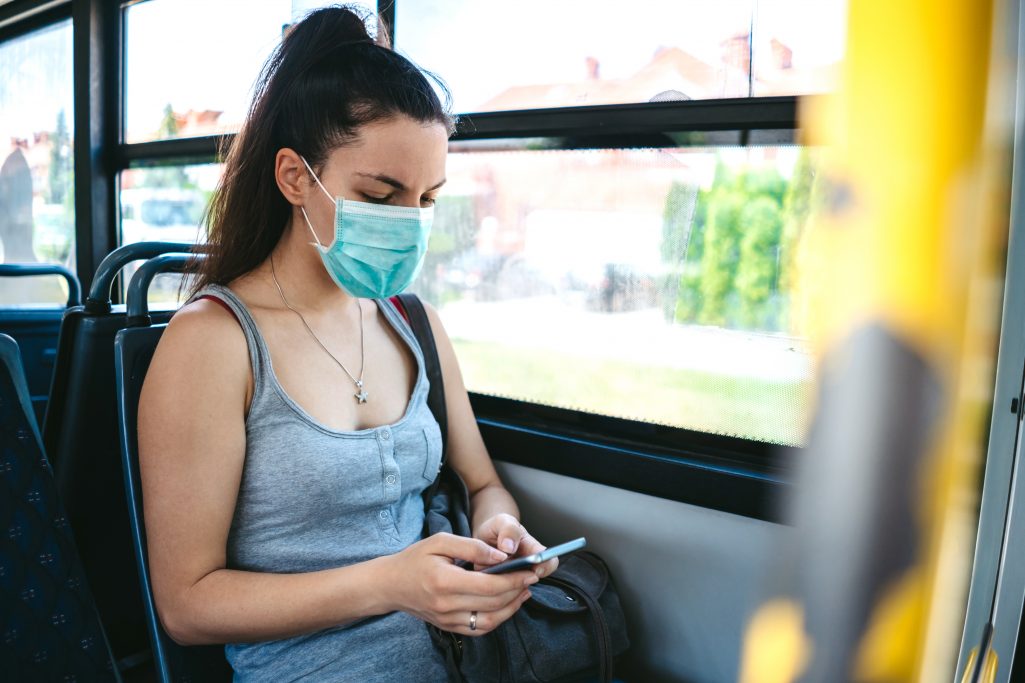 A woman on bus on her way to an appointment.