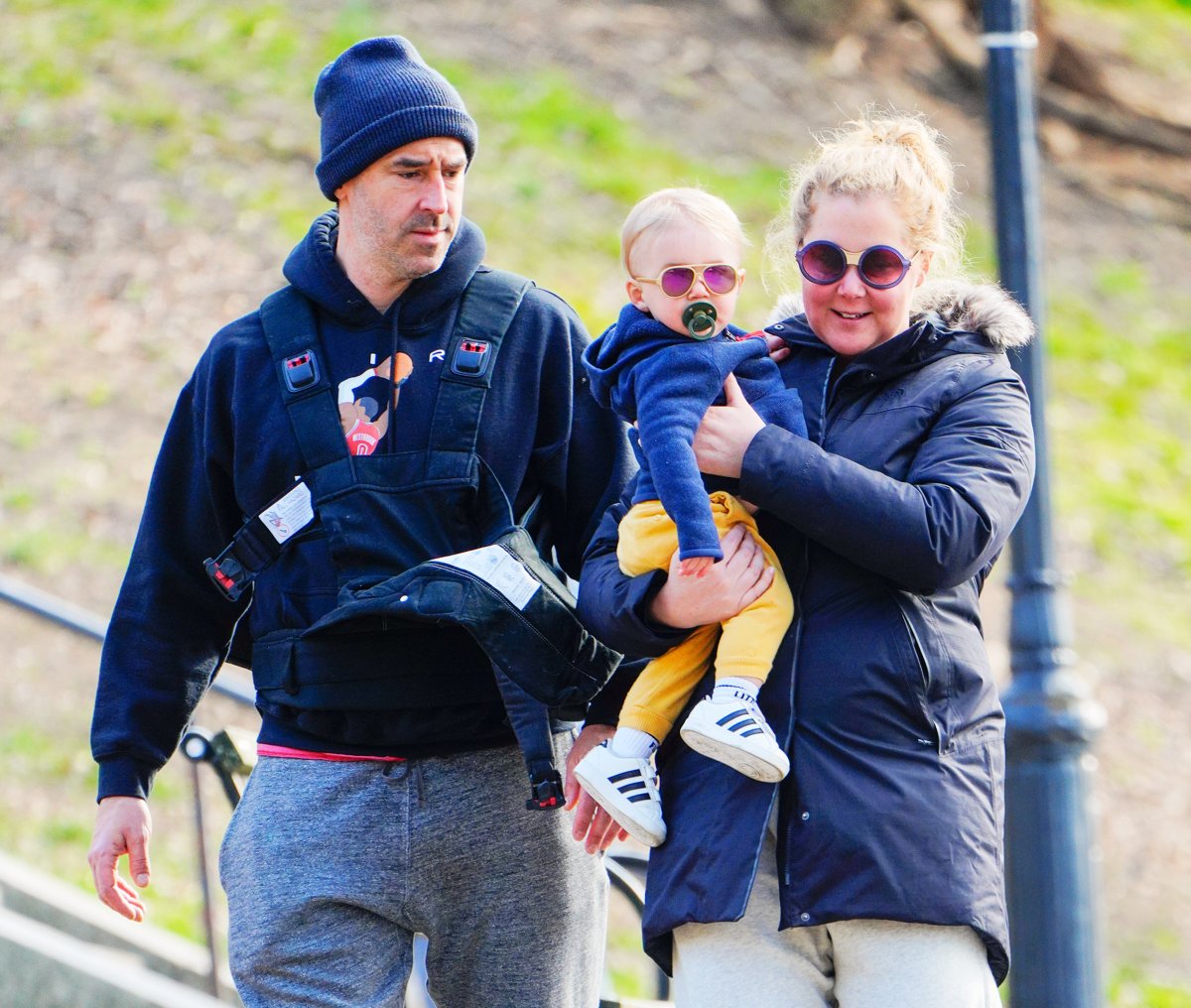 Amy Schumer and Chris Fischer take baby Gene Fischer out for some morning air on March 22, 2020 in New York City. 
