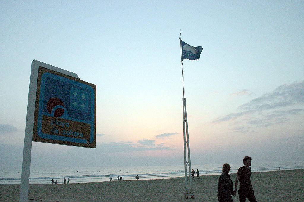 Zahara de los Atunes, Cadiz (Andalusia, Spain). EU (European Union) Blue Flag waving in the sunset at Zahara beach. 