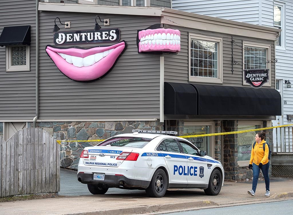 The Atlantic Denture Clinic is guarded by police in Dartmouth, N.S. on Monday, April 20, 2020.