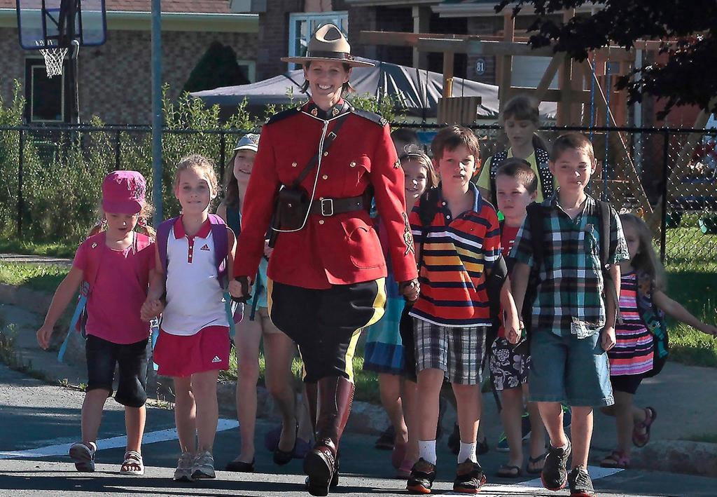 RCMP Const. Heidi Stevenson is shown with children in an undated hadout photo.