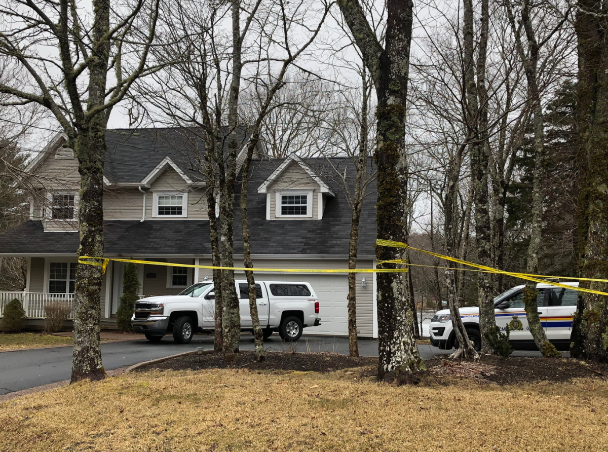 Investigators attend the scene of a homicide in April 2020.