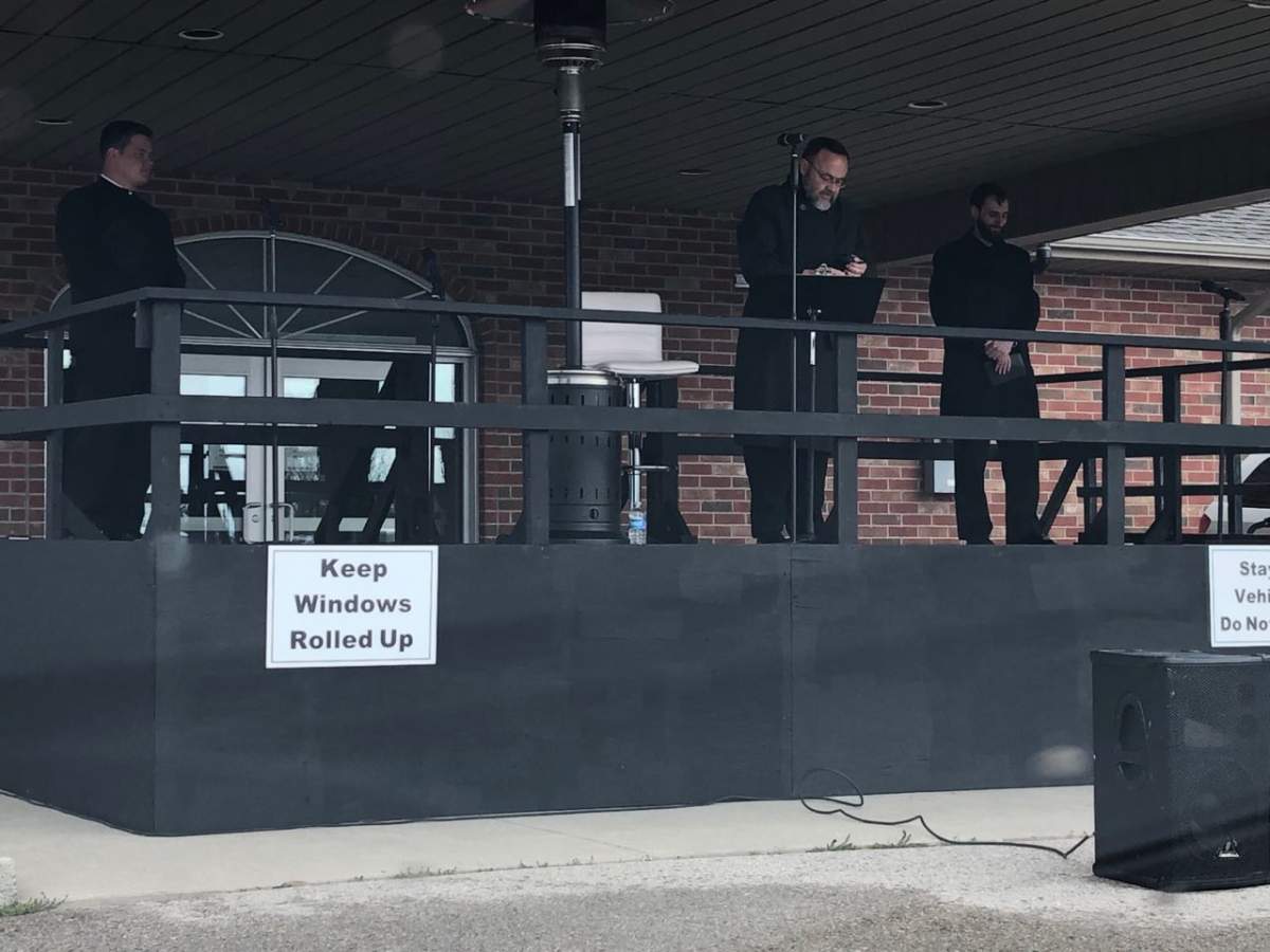 Pastor Hildebrandt (middle) at Sunday’s drive-in service