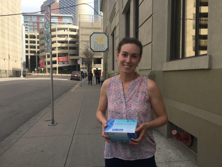 Samantha Lowe Health and Wellness manager at the Mustard Seed with box of surgical masks