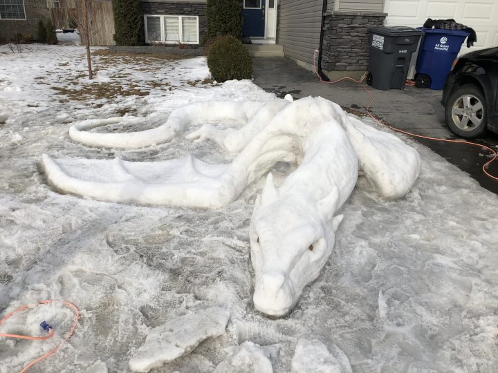 Saskatoon man, kids build dragon snow sculpture