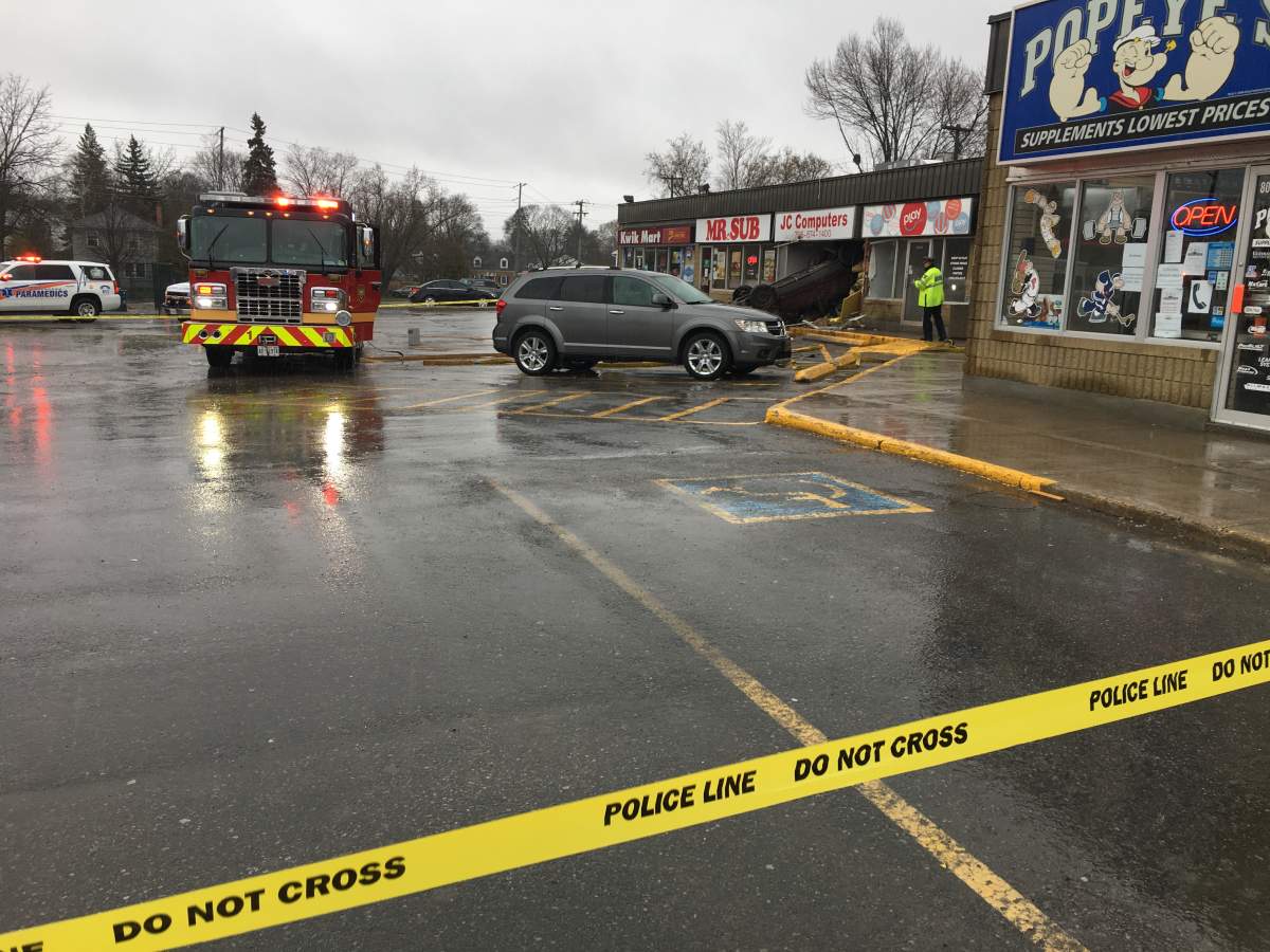 2 injured after vehicle flips and crashes into computer store in Peterborough - image