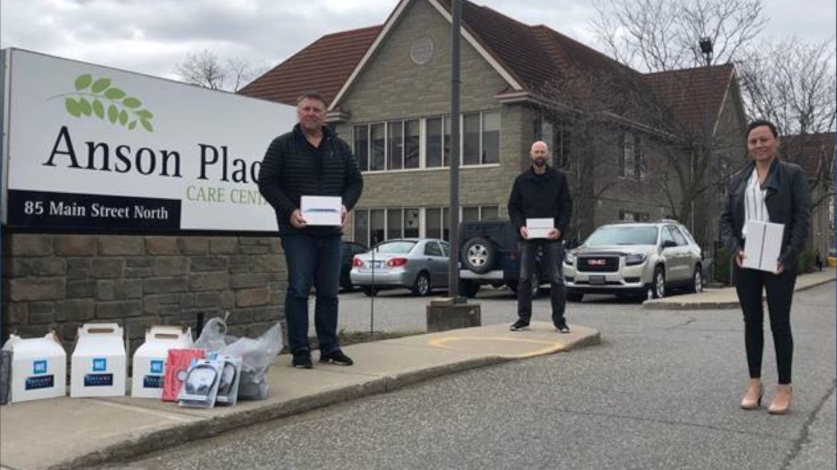 Haldimand County Mayor Ken Hewitt, Anson Place recreation volunteer Wesley Devries and, Norfolk County Mayor Kristal Chopp deliver iPads and headsets to residents at Anson Place.
