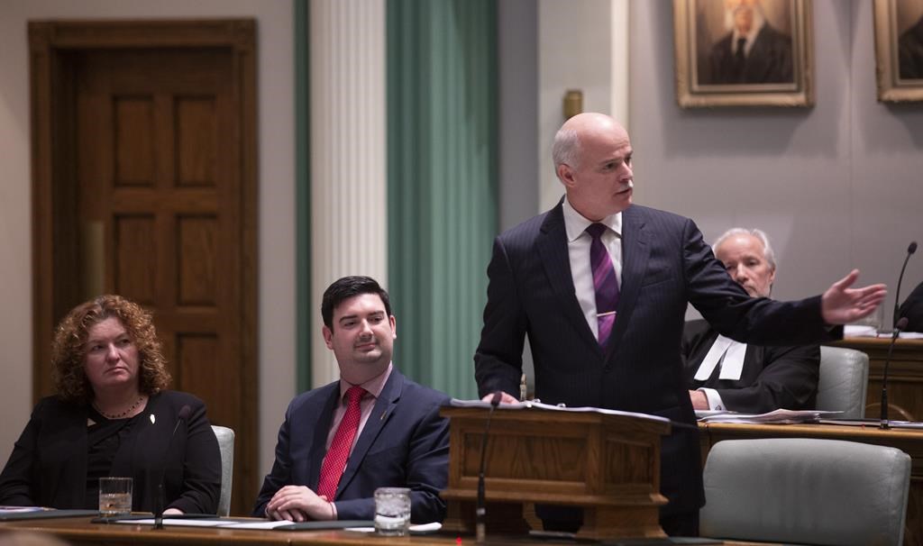 Sherry Gambin-Walsh, Minister of Service, left to right, and Christopher Mitchelmore, Minister of Tourism, Culture and Innovation listen as Finance Minister Tom Osborne presents the 2019 Budget in the House of Assembly in St. John's on April 16, 2019.