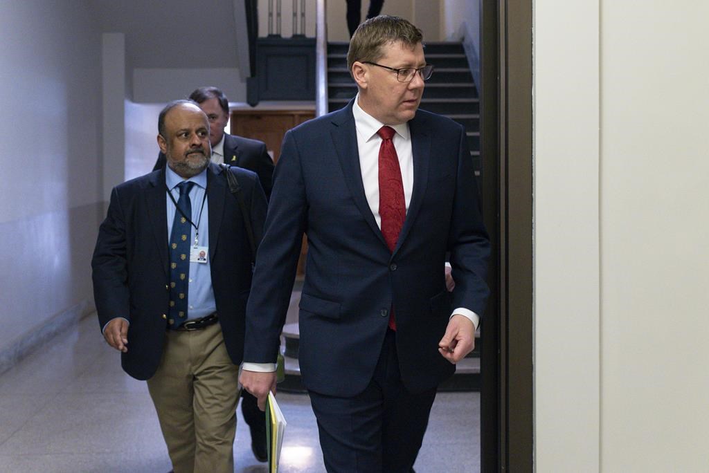 Saskatchewan Premier Scott Moe and Saqib Shahab, chief medical health officer, arrive to a COVID-19 news update at the legislative building in Regina on Wednesday March 18, 2020. 
