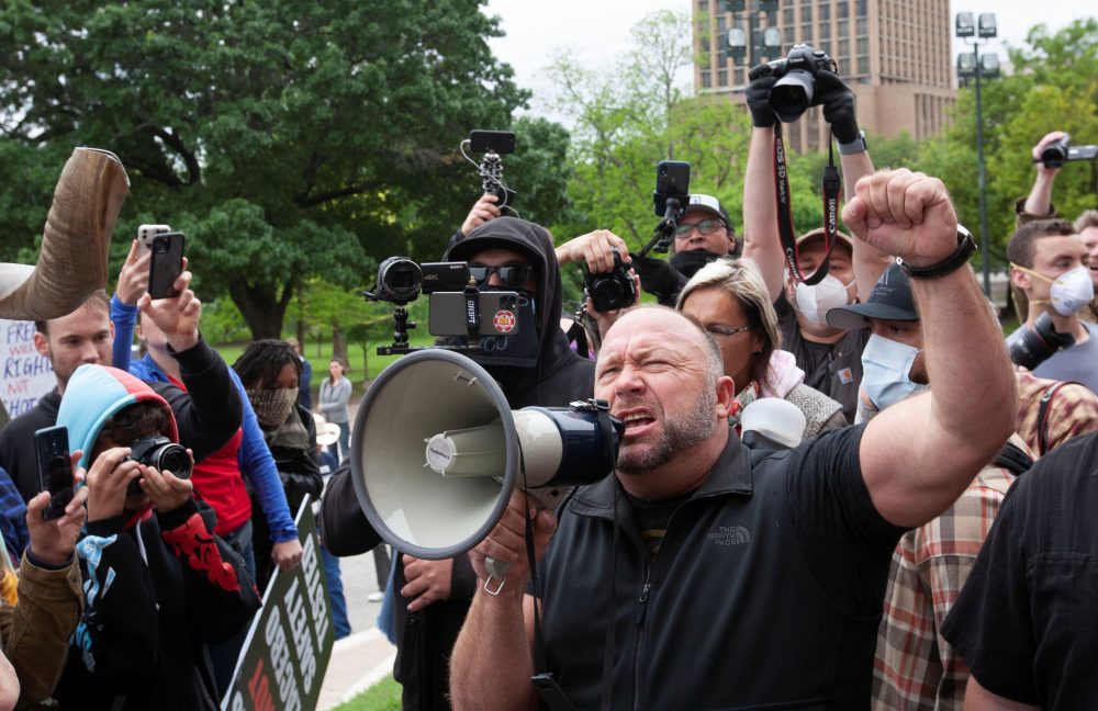 Alex Jones, the Infowars host and conspiracy theorist, speaks to protesters demonstrating against the state’s extended stay-at-home order to help slow the spread of COVID-19 at the Capitol building in Austin, Texas, U.S. April 18, 2020.