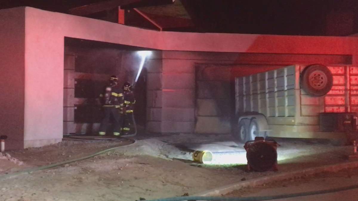 Firefighters at the site of a suspected arson in Kelowna on Saturday night.