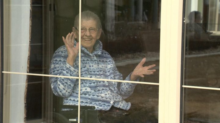 A Diamond House resident waves as the parade passes by.