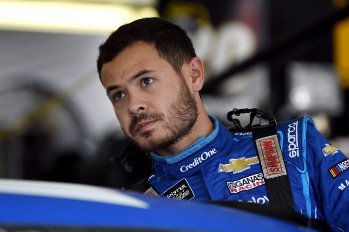 In this July 27, 2019, file photo, Kyle Larson climbs into his car for a practice session for the NASCAR Cup Series auto race in Long Pond, Pa.