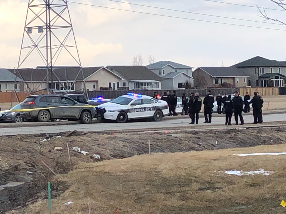 Multiple police officers gather at Lagimodiere Boulevard after a police-involved shooting April 8.