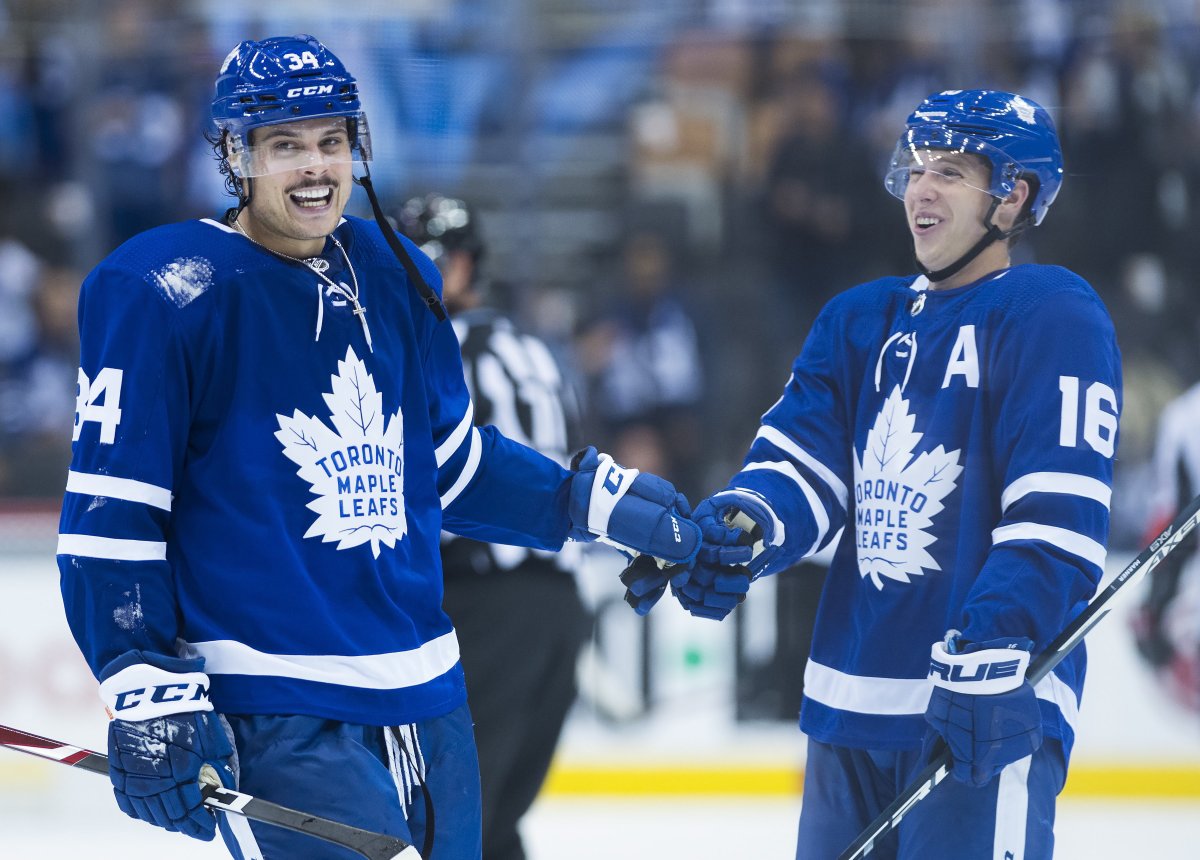 Toronto Maple Leafs centre Auston Matthews (34) and teammate Mitch Marner (16) laugh after defeating the Ottawa Senators on Oct. 2, 2019.
