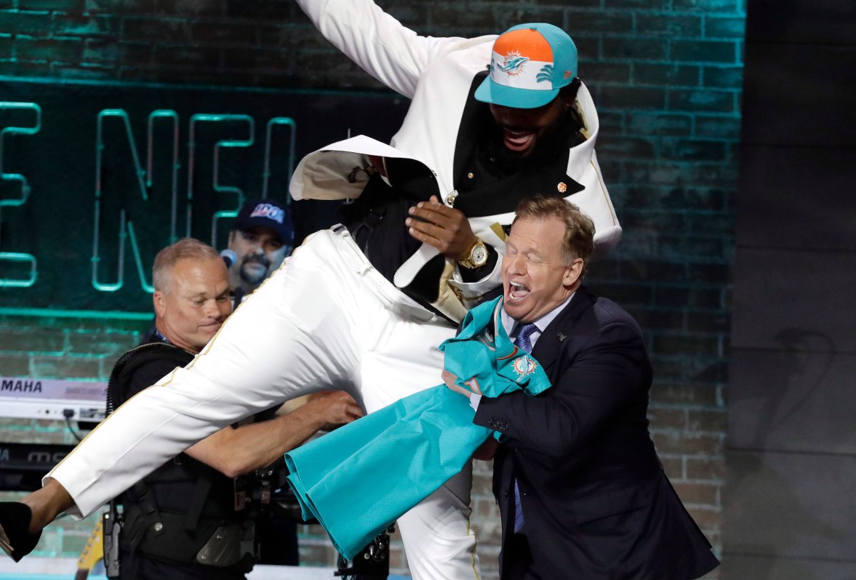 Clemson defensive tackle Christian Wilkins jumps into NFL commissioner Roger Goodell's arms after the Miami Dolphins selected Wilkins in the first round at the 2019 NFL football draft in Nashville, Tenn.