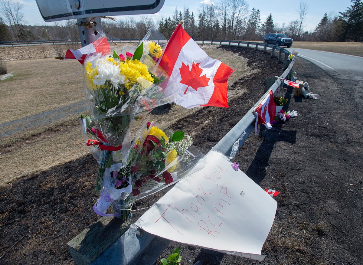A memorial pays tribute to RCMP Const. Heidi Stevenson, a 23-year member of the force and mother of two, along the highway in Shubenacadie, N.S. on Tuesday, April 21, 2020. RCMP say at least 19 people are dead, including Stevenson, after a man who at one point wore a police uniform and drove a mock-up cruiser, wemt on a murder rampage in Portapique, and other Nova Scotia communities. The alleged killer was shot and killed by police. THE CANADIAN PRESS/Andrew Vaughan.