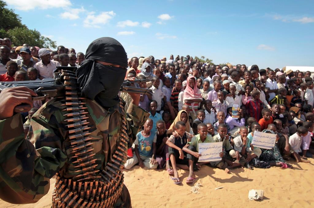 FILE – In this Feb. 13, 2012, file photo, an armed member of the militant group al-Shabab attends a rally on the outskirts of Mogadishu, Somalia. (AP Photo, File)