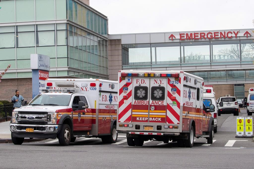 FILE: FDNY ambulances are seen entering and leaving the emergency room at Queens Hospital Center, Monday, April 20, 2020, in the Jamaica neighborhood of the Queens borough of New York. 