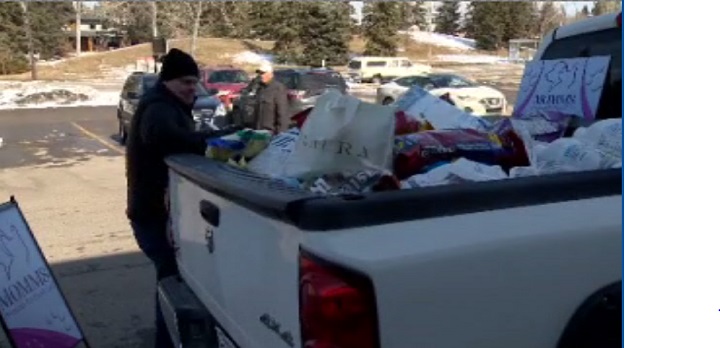 Pet food donations  destined for the Calgary Food Bank are loaded into a truck Saturday, April 4, 2020.