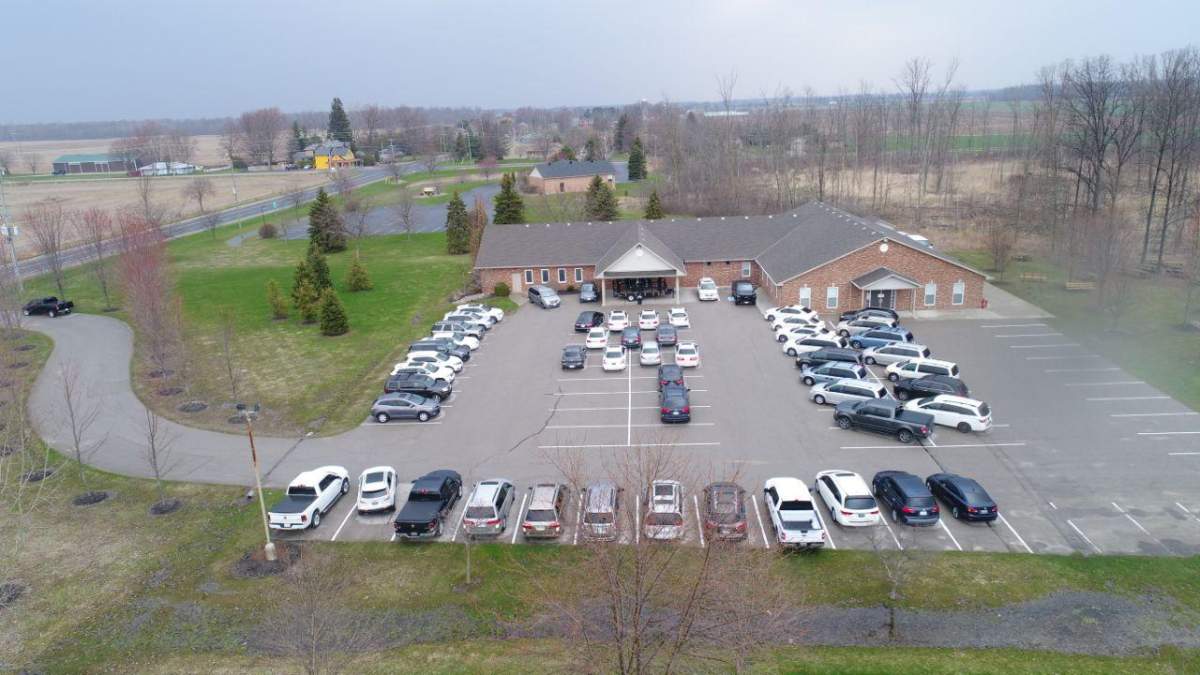 An aerial image captures a full parking lot at the Church of God in Aylmer, Ont., as drive-in church service takes place Sunday morning.