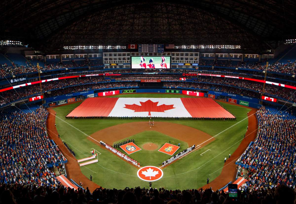 A giant Canadian flag is displayed during the national anthem at Rogers Centre in Toronto.