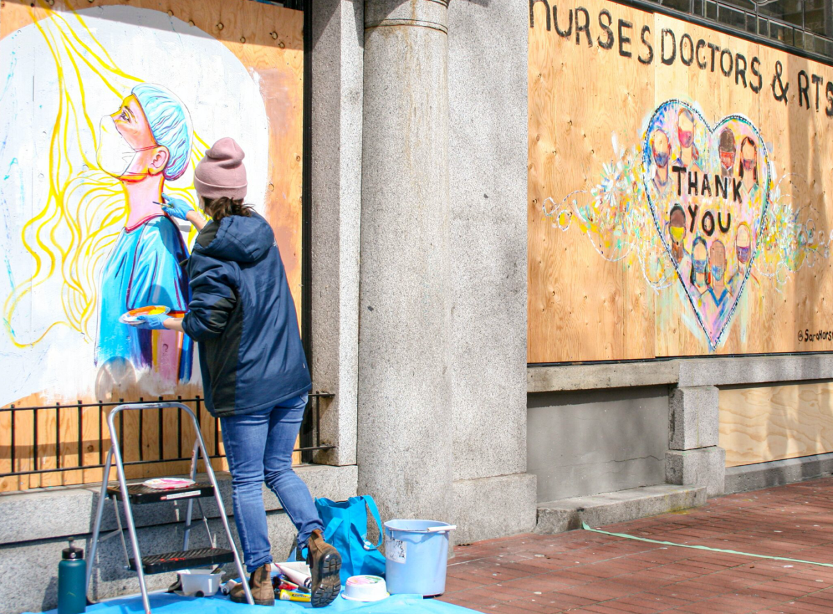 Local artist Mårïna paints a mural on a downtown Vancouver business during the COVID-19 pandemic.