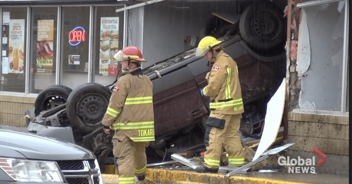 Firefighters assess the crash outside JC Computers.