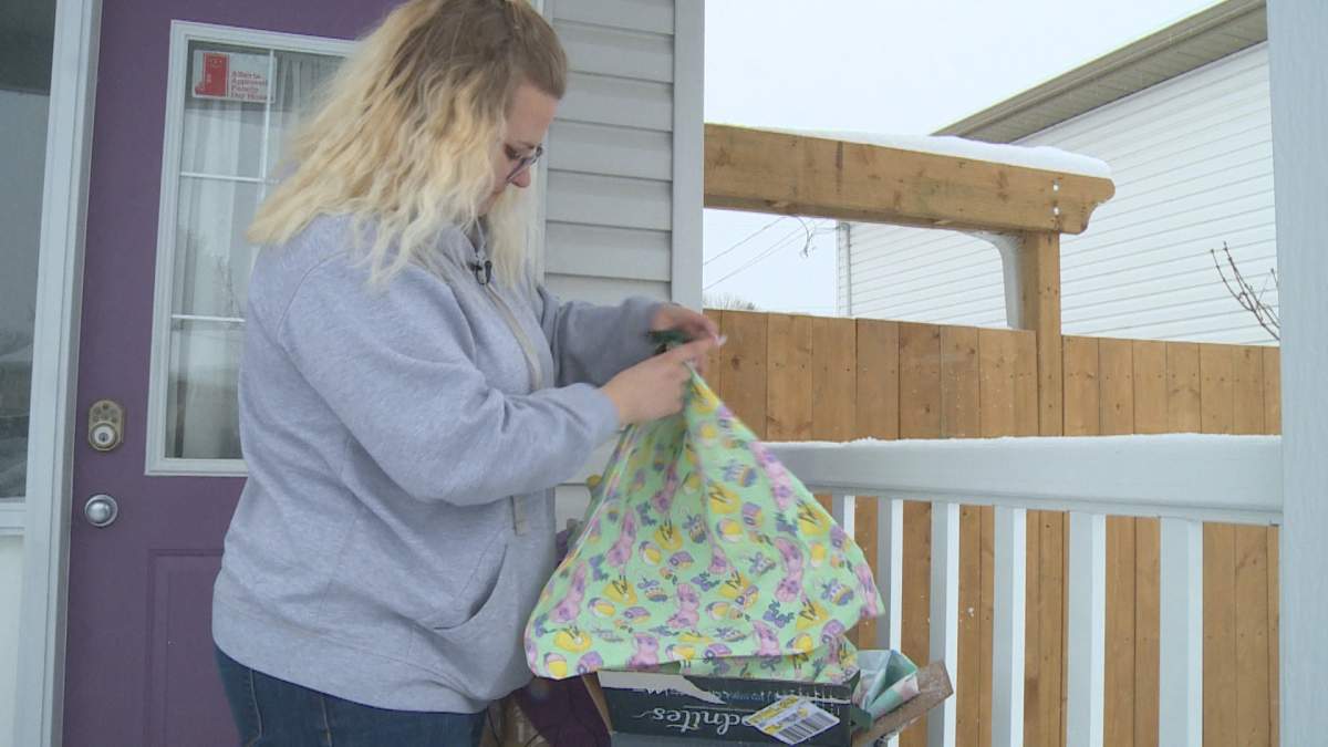 Cora Walkey shows off the reusable bags Stitch It Forward is donating to health-care workers in and around Lethbridge.