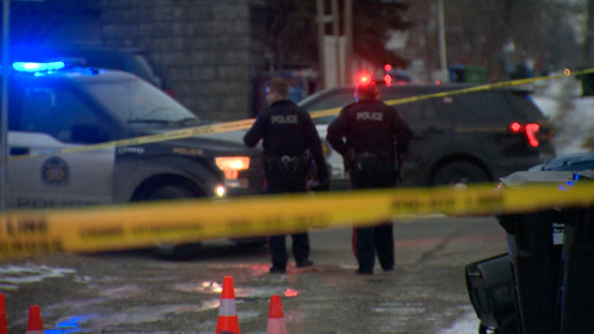 Officers canvass a Calgary neighbourhood after a shooting April 5, 2020.
