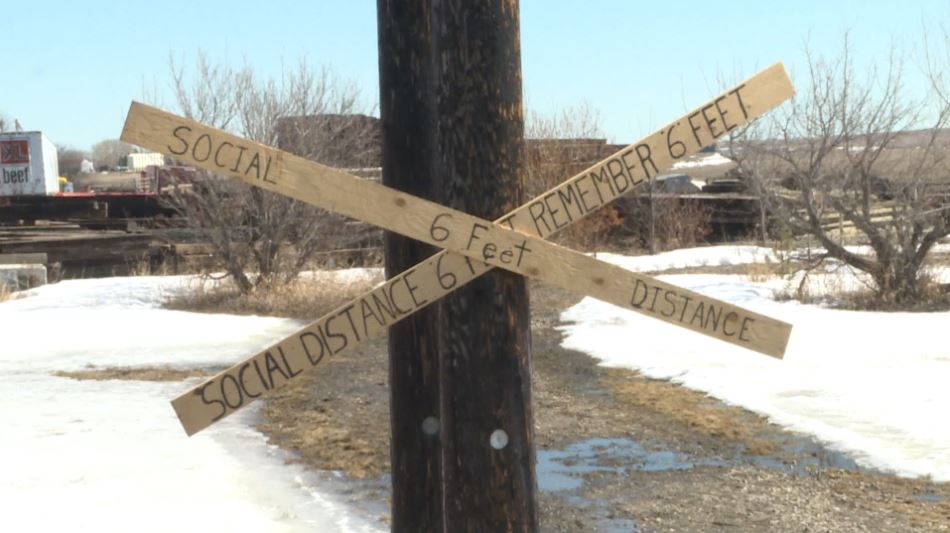 A sign at the Aspen Crossing Campground, southeast of Calgary, reminding campers to maintain social distancing.