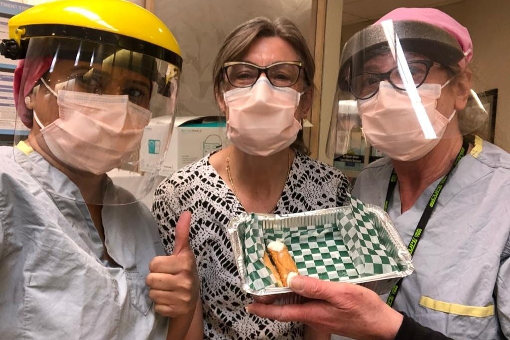 Health-care workers at Hamilton's Urgent Care Centre pose with (the remainder of) a donation of cannoli from a local food truck.