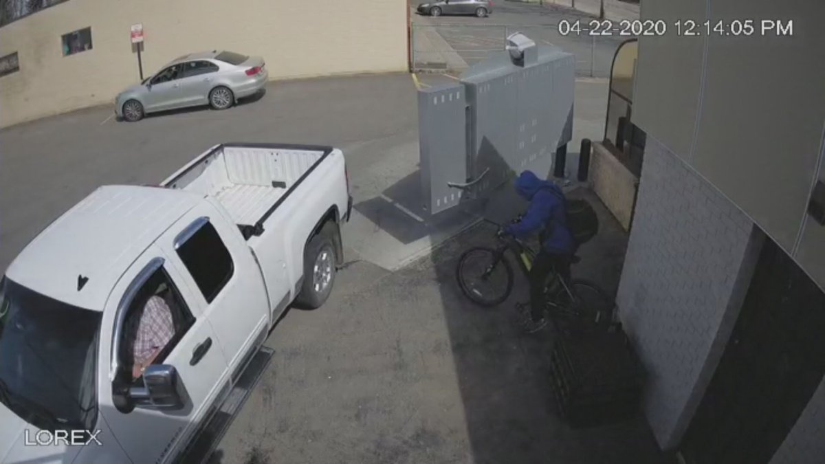 A man is seen stealing an electric bike outside a Dairy Queen restaurant in Lethbridge, Alberta on April 22. 