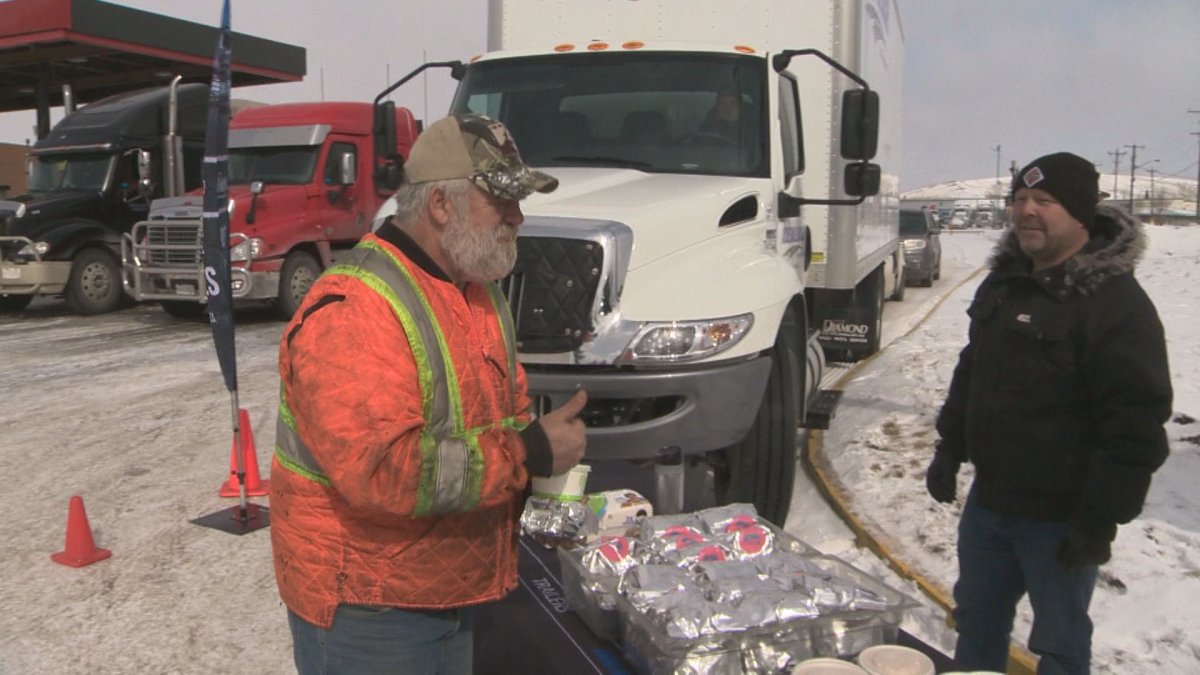 Truck driver Rob Walsh picks up a free lunch provided by Diamond International Trucks. COVID-19 has shut down many restaurants and washrooms for truckers.
