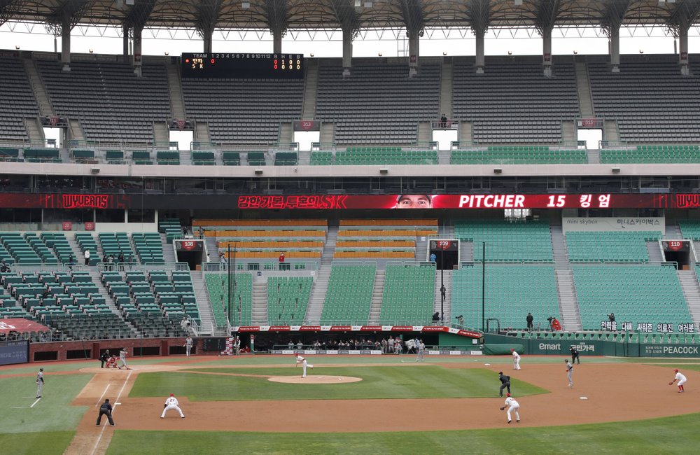 Stadium seats are empty as a part of precaution against the new coronavirus during a baseball game between Hanwha Eagles and SK Wyverns in Incheon, South Korea, Tuesday, May 5, 2020. With umpires fitted with masks and cheerleaders dancing beneath vast rows of empty seats, a new baseball season got underway in South Korea following a weeks-long delay because of the coronavirus pandemic.
