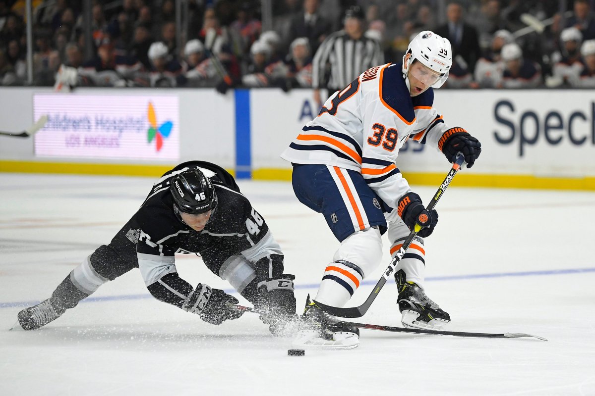 Los Angeles Kings center Blake Lizotte, left, and Edmonton Oilers right wing Alex Chiasson battle for the puck during the first period of an NHL hockey game Sunday, Feb. 23, 2020, in Los Angeles. (AP Photo/Mark J. Terrill).