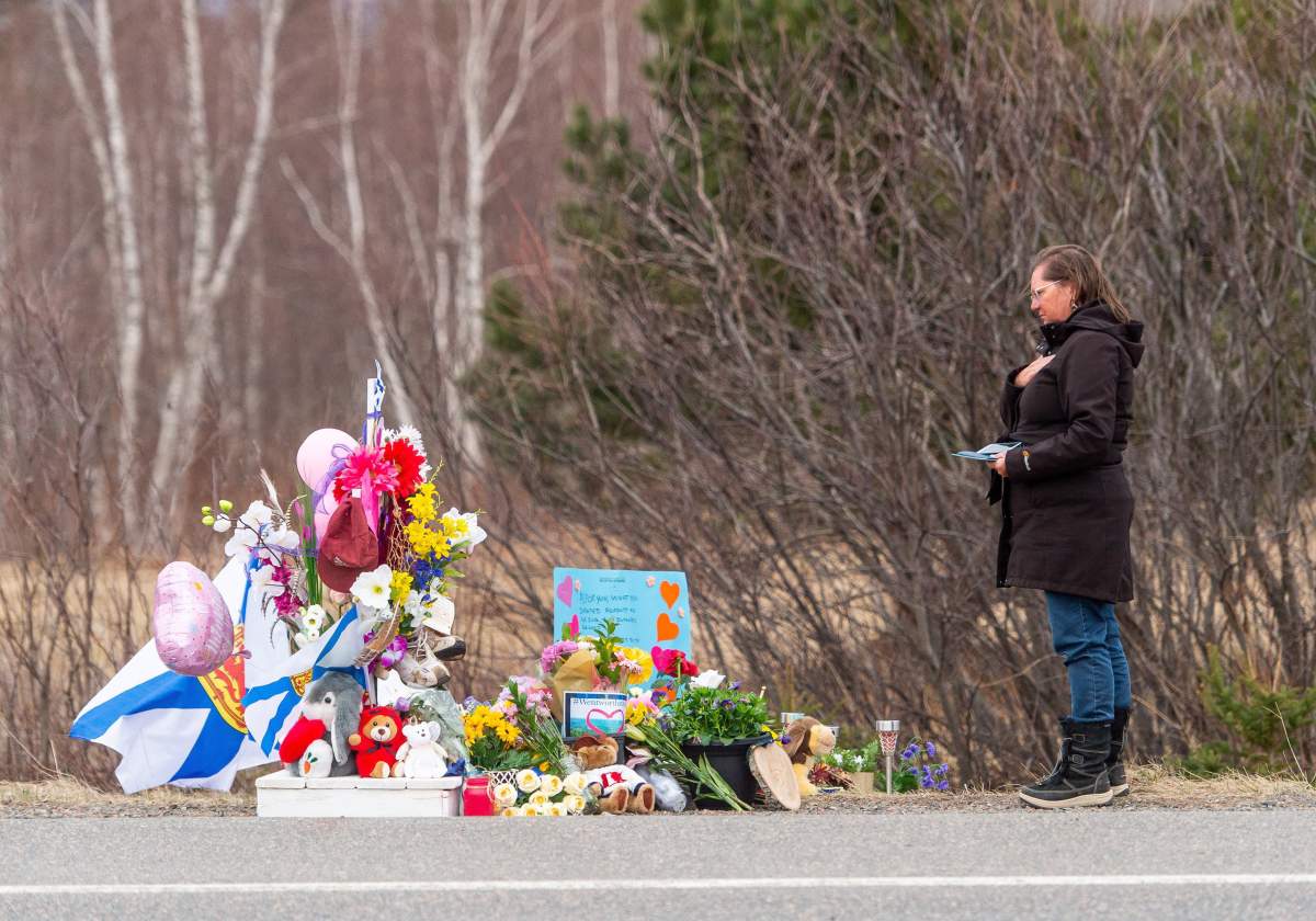 Christine Heart stops to pay her respects at roadside memorial for Lillian Hyslop in Wentworth, N.S. on Friday, April 24, 2020. 22 people are dead after a man went on a murderous rampage in Portapique and several other Nova Scotia communities.