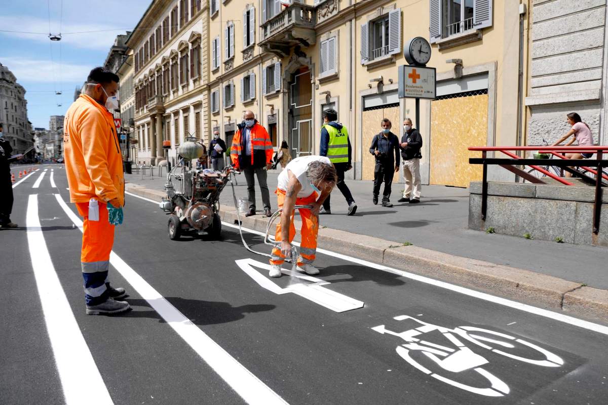 Workers apply paint on the bike path in Venezia street ahead of Phase 2 of the Coronavirus emergency, in Milan, Italy. May 2nd 2020.