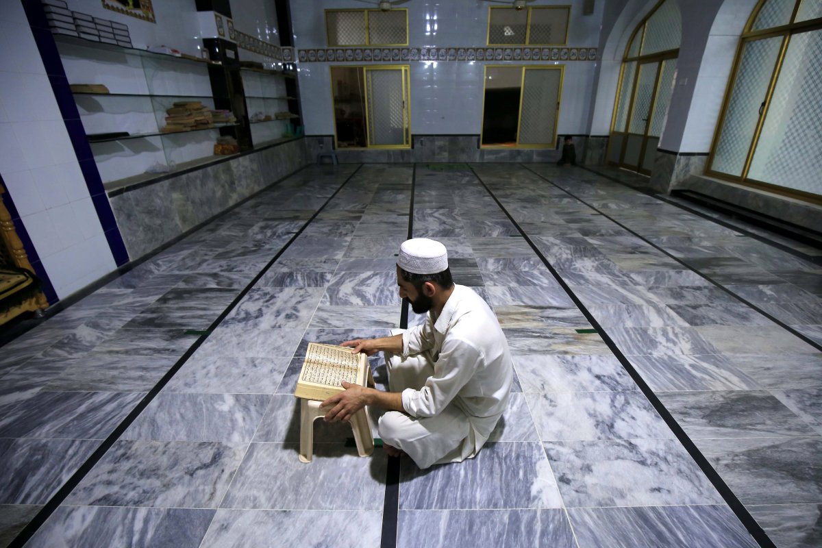 File photo -- A Pakistani Muslim man reads verses from the holy Koran at a Mosque during the Muslim holy month of Ramadan amid lockdown of the Khyber Pakhtunkhwa province due to the ongoing coronavirus COVID-19 pandemic, in Peshawar, Pakistan, 04 May 2020. 