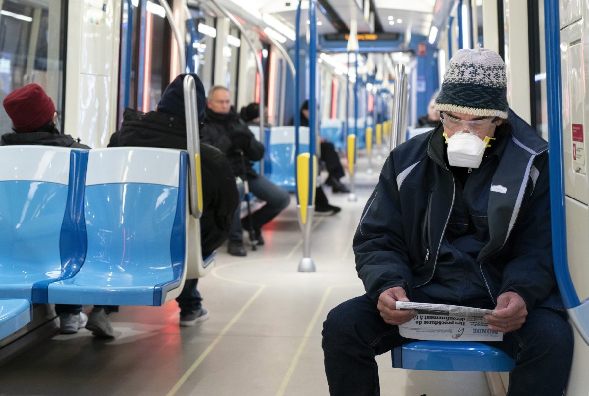 Commuters keep their distances in a subway train in Montreal, on Wednesday, April 22, 2020.