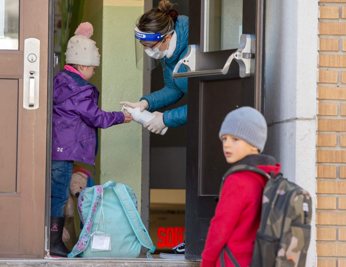 FILE: Students get their hands sanitized as they enter Ecole Marie Rose as elementary schools outside the greater Montreal area reopen.