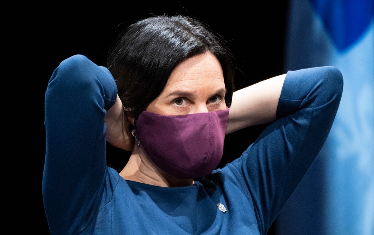 Montreal Mayor Valerie Plante slips on her protective mask during a news conference in Montreal, on Thursday, May 14, 2020.