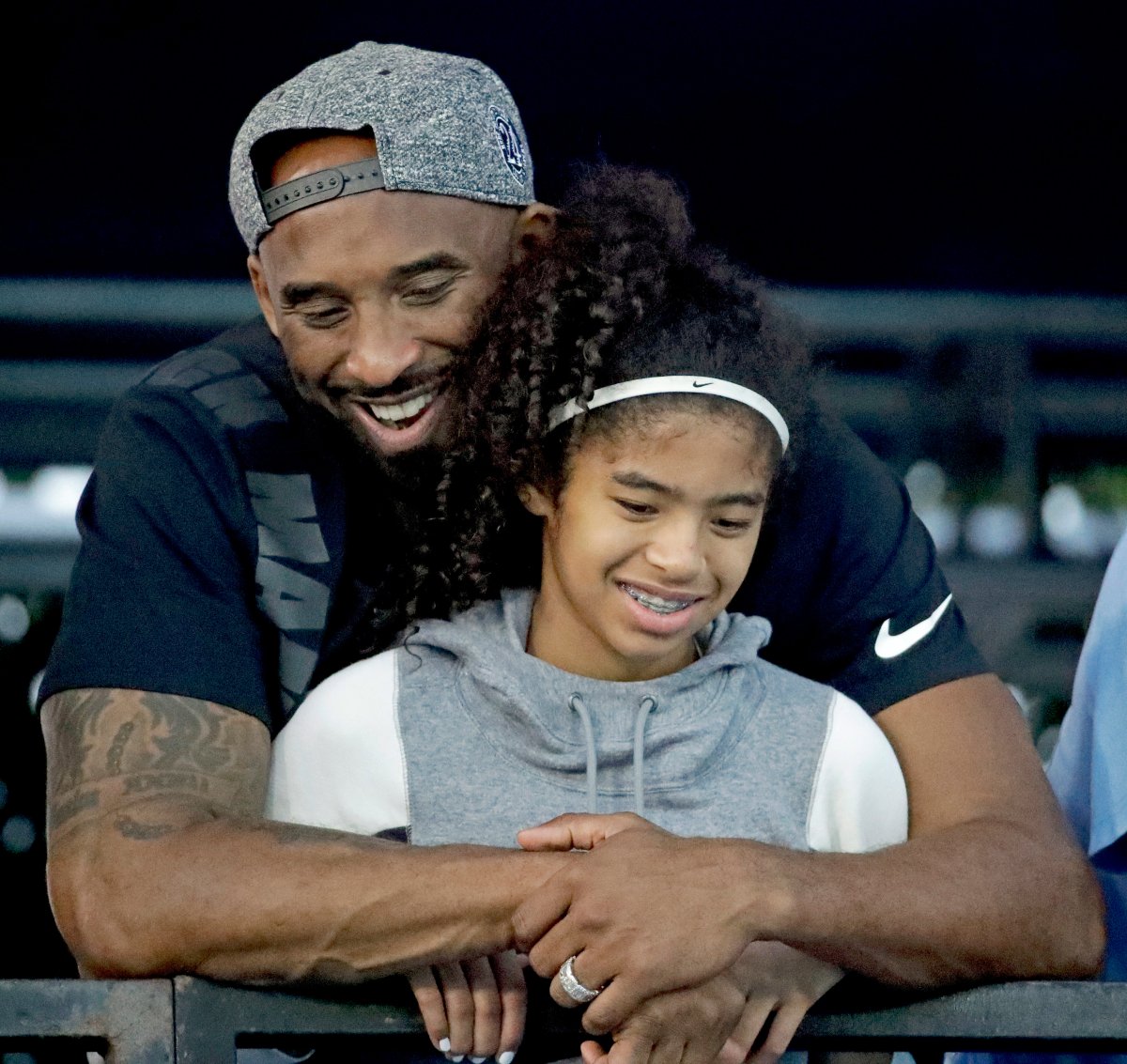 FILE - In this July 26, 2018, file photo, former Los Angeles Laker Kobe Bryant and his daughter Gianna watch during the U.S. national championships swimming meet in Irvine, Calif.