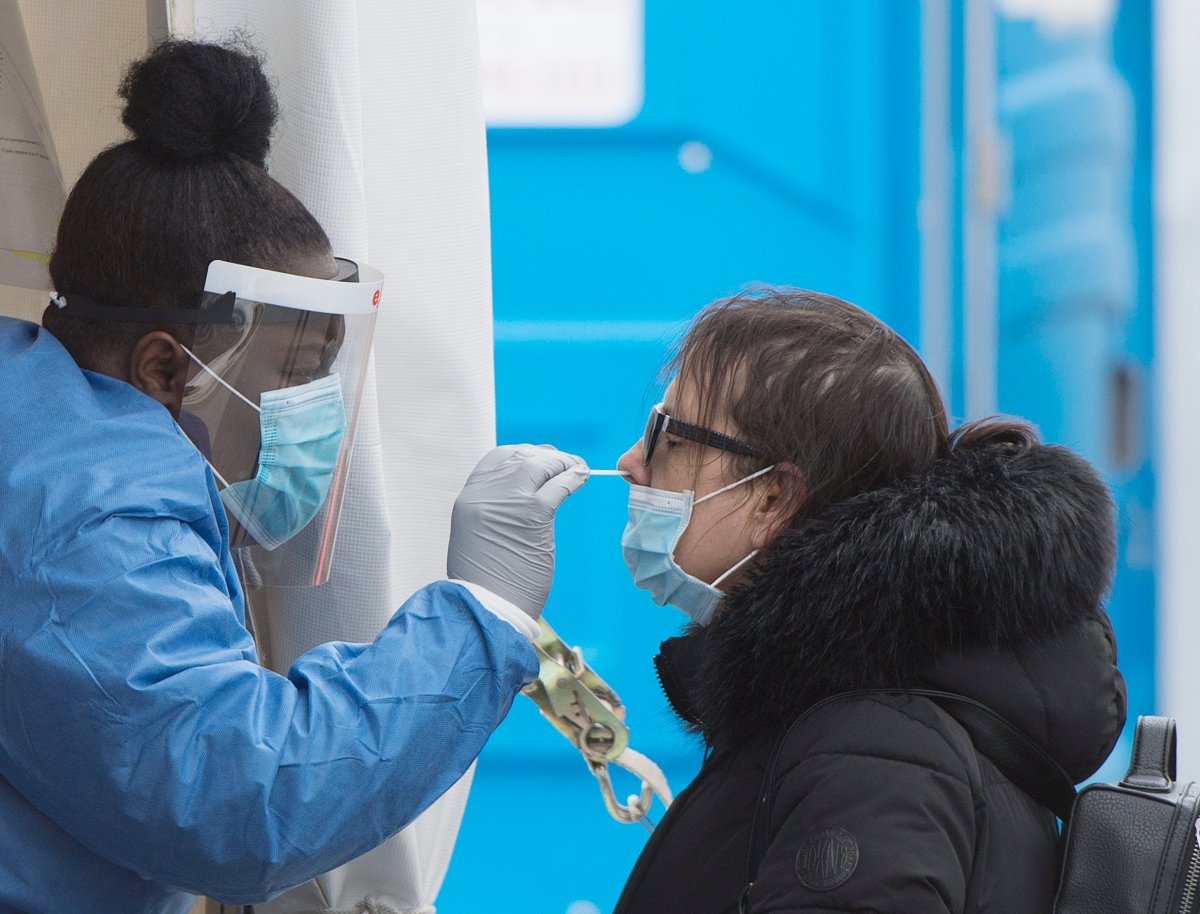 A health-care worker swabs a woman at a mobile COVID-19 testing clinic in Montreal, Sunday, May 10, 2020. Peterborough Public Health reports ?? cases in its jurisdiction on Tuesday.