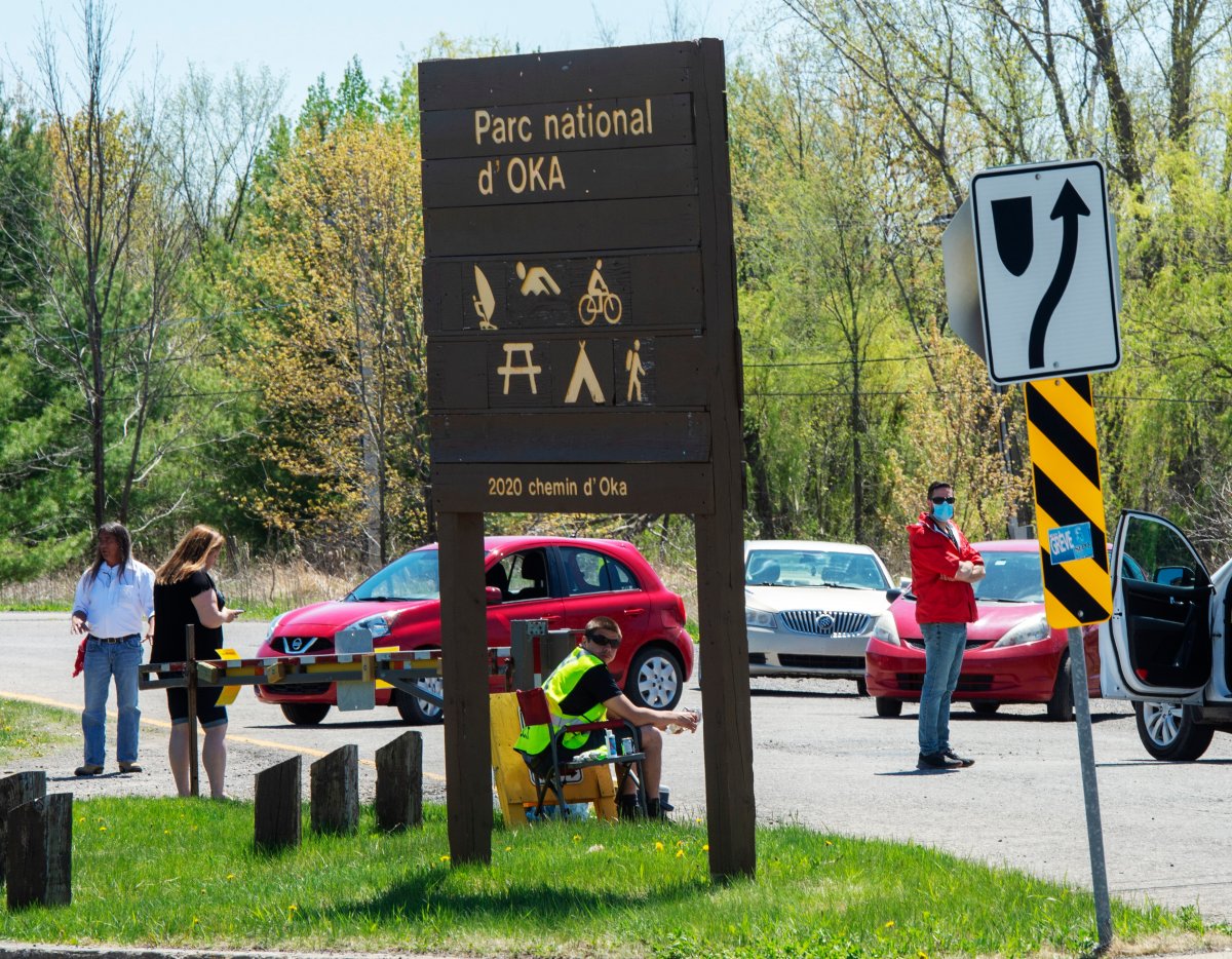 Mohawks from Kanesatake block the entrance to Oka provincial park, Wednesday, May 20, 2020 in Oka, Que.