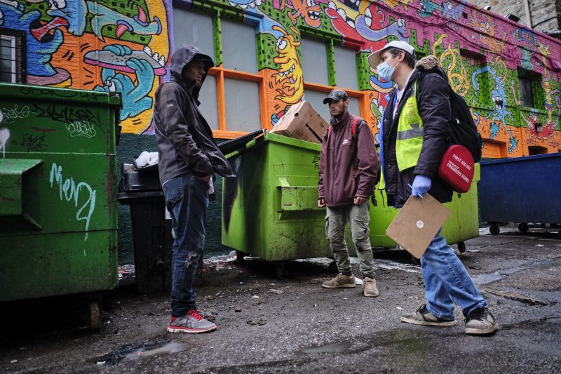 Chaz Smith, right, talks with Gordon Kelter who is homeless in Calgary.