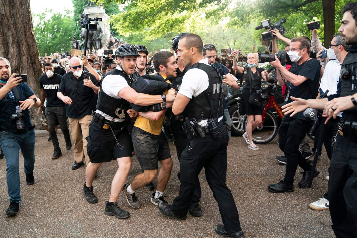Uniformed U.S. Secret Service officers detain a demonstrator during a protest about the death of George Floyd, a black man who died in police custody in Minneapolis, Friday, May 29, 2020, in Washington. (AP Photo/Evan Vucci)